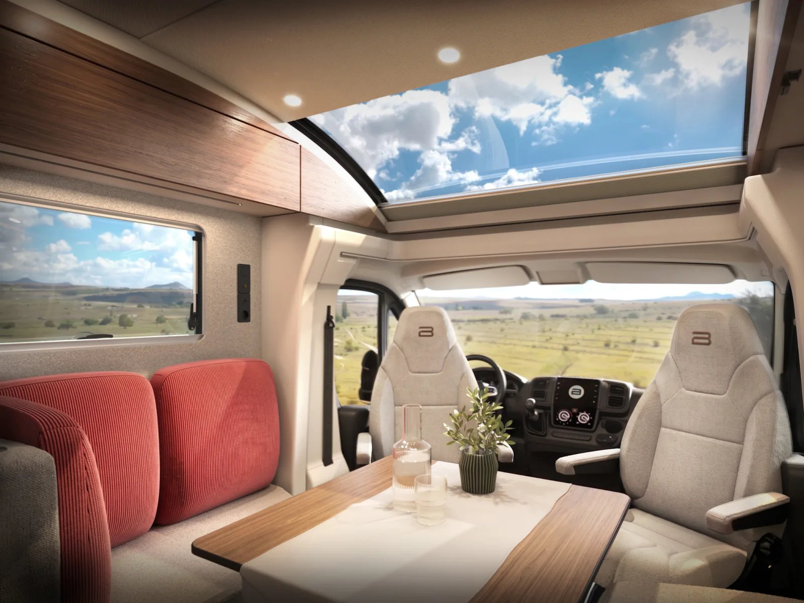 Sitzgruppe im Bürstner Signature Fiat mit Holztisch, gedrehten Fahrerhaussitzen und großem Dachfenster, Landschaft hinter der Windschutzscheibe